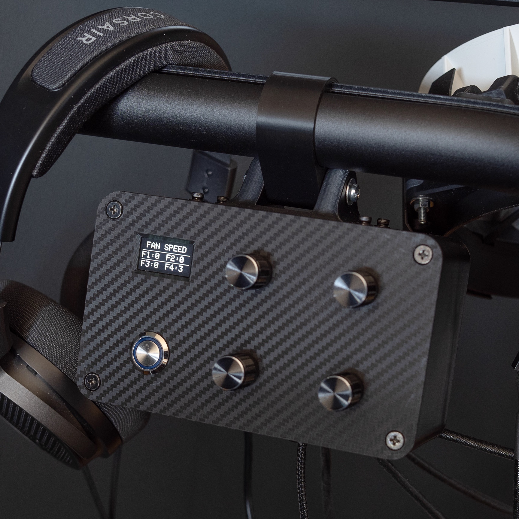 YTEM fan controller finished in carbon, dials and display mounted where they are reached from the wheel